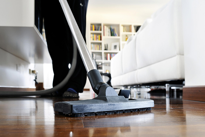 maid vacuum cleaning floor